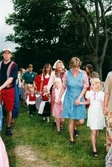 Midsommarfirande vid Gunnebo slott i Mölndal, okänt årtal. Små och stora deltar i dansen kring midsommarstången.