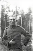 Repetitionsövningarna vid I11 i Växjö, hösten 1921.
En man i uniform med en cigarett i handen, i ett skogsbryn.