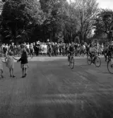 Studenterna, 1939. Studenter och anhöriga på väg över järnvägen, mot Norra Järnvägsgatan. Till höger skymtar dåv. Järnvägsrestaurangen (nuv. Domprostgården).