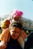 Påskfirande på Mölndals torg lördagen den 3 april 1999. En påskkärring sitter på en mans axlar.