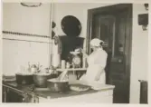 Kokerskan Hilma Olsson (bördig från Skåne) bakar i köket, Stretereds vårdhem okänt årtal. Hennes son, Åke Olsson, var fosterbarn i Vommedal Östergård 
