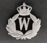 Mössmärke i mässing. 