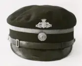 Äldre fjärdingsmansmössa, med kokard. Mössmärke i mässing, avbildande Smålands landskapsvapen under hertigkrona.