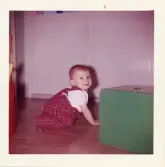 Fotografi på pojken Tex krypandes på golvet, troligen i Lilla Källbäck.