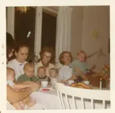 Fotografi på kvinnorna Inger Berglund, Barbro Berglin och Margareta Söderberg med många barn i sina knän, julen 1969 på Lilla Källbäck.