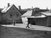Två män spelar badminton. Nordiska Kompaniet.