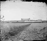 Uppsala centralstation med godsmagasinet och banvallen från öster, Uppsala efter 1866