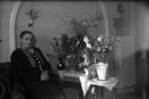 Fru Hanna Christensson på Tegane bland blommor i rumsinteriör