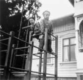 Bosgårdens barnträdgård 1938-1945. Två pojkar som klättrar i en klätterställning.