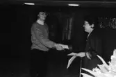 Prisutdelning i Mölndals stadshus vid tävling om Mölndals souvenirer i februari 1992. Konstintendent Bodil Magnusson, till vänster, vann andrapris. Den som delar ut blommorna är Kultur- och fritidsnämndens ordförande, Sonja Knutsson.
