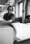 En kvinna sorterar och räknar papper på Papyrus, 12/5-1970.

Fotograf: Rolf Salomonsson, Wezäta studio, Grafiska Vägen Box 5057, 
402 22 Göteborg 5 Växel 031/40 01 40