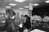 Ny fiskaffär, Fiskhörnan, på Hagabäcksleden i Kållereds centrum, år 1983. Christina Sjöbring betjänar kund.

För mer information om bilden se under tilläggsinformation.