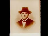 En äldre man med hatt, bröstbild. 
Beställare: fru Ester Karlsson
