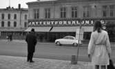 Epa 24 april 1968. Utförsäljning.

Storgatan med trafik.

En herre och en dam i förgrunden väntar på bussen.