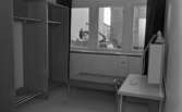 Teatervisning (forts.) den 27 februari 1965.

Garderob på Hjalmar Bergmanteatern. Utanför fönstret i bakgrunden skymtar en arbetare.
59.26585, 15.21948