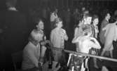 Minnenas 23 maj 1966

Dans i Brunnsparken. Massor med par av kvinnor och män dansar i bakgrunden. I förgrunden sitter en kvinna vid ett bord fyllt med flaskor med sugrör i samt handväskor.