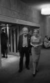Premiär Julie, 28 februari 1966

 I förgrunden syns en dam i fin klänning samt en herre i kostym och väst. De befinner sig inne i teatern. I bakgrunden syns andra uppklädda personer.