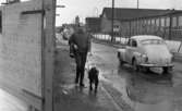 Blind kille 7 april 1966

En blind man promenerar med sin svarta ledarhund - en labrador. En bil kör förbi dem. Den har registreringsnummer
