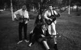 Modellbåts-SM, Mosås 21 augusti 1967

En musikgrupp bestående av en kvinna och tre män. Två av männen står upp med gitarrer i sina händer. I mitten sitter kvinnan klädd i tröja och byxor invid den tredje mannen som också har en gitarr i sina händer. Tre av medlemmarna har sandaler på fötterna.