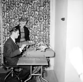 National Kassa Register AB, kontorsmaskiner, interiör, två personer.