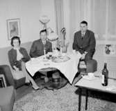Rumsinteriör, tre personer vid bordet.
Gösta Karlbergs 50-årsdag.