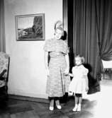 Rumsinteriör, en kvinna och en liten flicka.Bertil Sehlin (beställare).