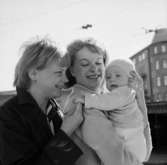 Familjegrupp tre personer vid Centralstationen. Janna reser till Halland.
Bostadshus i bakgrunden.
