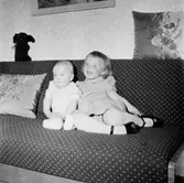 Rumsinteriör, två barn i soffan.
Harold Molin