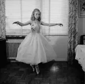 Rumsinteriör, en flicka, balettdansös.
Sörling