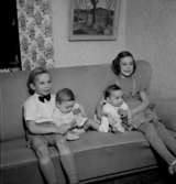 Rumsinteriör, fyra barn i soffan.Fru Blomberg