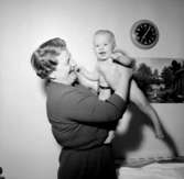 Rumsinteriör, en kvinna och en baby.Rudolf Rittbergs dotter, 4 månader gammal.