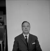 En man, bröstbild.
Oscaria Skofabrik.