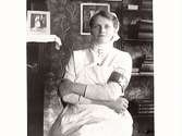 Porträtt av en sjuksyster i hem-miljö. Kvinnan kan möjligen vara Laura Albrektsson.