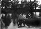 Örebro kolonien.
Tre kvinnor i en roddbåt.