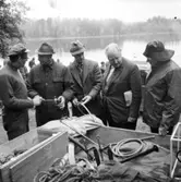 En grupp män samtalar vid fiskeutrustning  den 29 september.