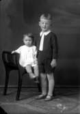 Ateljébild på två barn. Enligt Walter Olsons journal är bilden beställd av fru Anna Olsson.