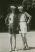 Två modeller i shorts, linne, Kimono-jackor och matroshattar, poserar vid Saltsjöbaden.