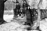 Tre kvinnor i Stadsträdgården. De poserar vid en träbro.