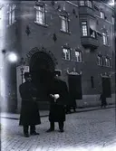 Två poliser i pälsmössor och rockar patrullerar vid korsningen Storgatan-Kaggensgatan.
I bakgrunden Handelsbankshuset, som uppfördes 1913 efter ritningar av stadsarkitekten i Malmö A. Stoltz.