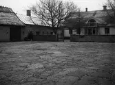 Gårdsinteriör med mangårdsbyggnad.