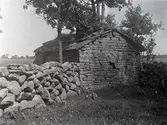Uthus av sten och tak av flisplattor.