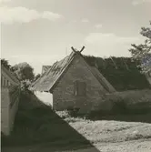 Ladugård uppförd i sten med stråtak.