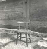 En stol och träfasad i Folkeslunda.