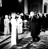 Skara. 
Skaraborgs Lucia 1965, Ewa Hornvall, kröning med biskop Sven Danell.