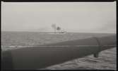 Jagaren NORDENSKJÖLD fotograferad från annat fartyg; eldrör på kanon i förgrunden.