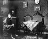 Interiör, sittande kvinna.