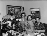 Fem kvinnor i bostadsmiljö omgiven av blommor, Östhammar, Uppland