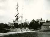 Skonare vid lastkajen. Gustavsbergs kyrka i bakgrunden, färdigställd 1907. Till höger i bakgrunden skymtar Värdshuset.