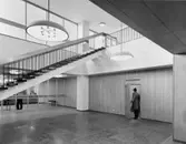 Entréhallen på nedre botten. Fönstervägg mot Tegnérlunden. T.v. skymtar postexpeditionen Stockholm 45, vilken har ingång från entréhallen. Dörren t.h. leder till postexpeditionens box- avdelning.