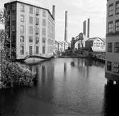 Industriområde på Laxholmen mitt i Motala ström. Till vänster en byggnad som kallas Strykjärnet som numer inhyser Arbetets Museum. Det byggdes 1916-1917.